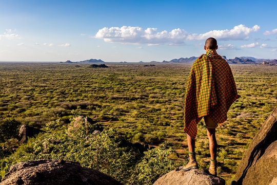 A Karamojong man looking out at the landscape in eastern Uganda.